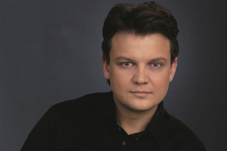 Портрет Дмитрия Попова на фоне Латвийской оперы